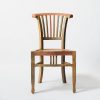 A rustic wooden chair featuring an artistic multicolor design against a white background.