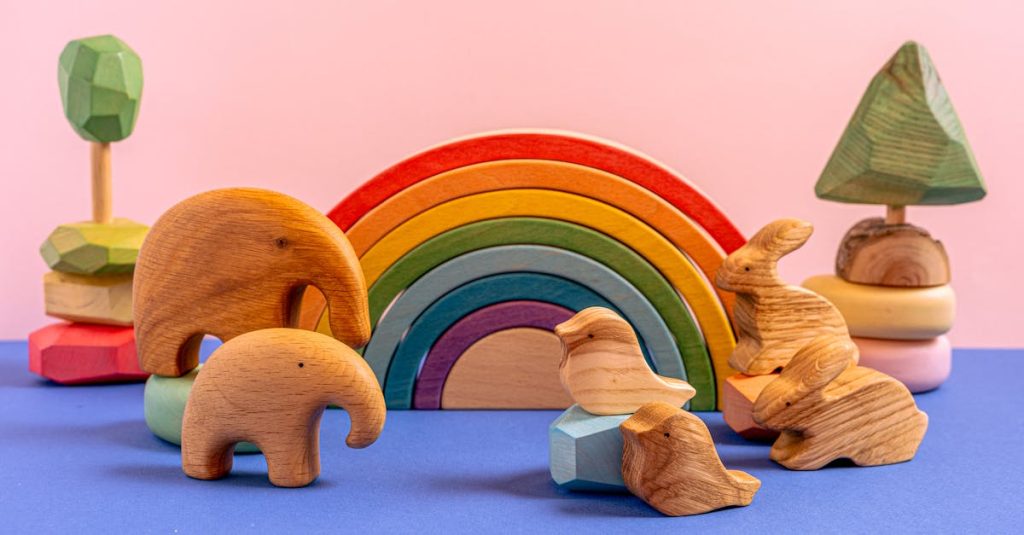 A vibrant still life of wooden animal toys and a rainbow on a colorful background.